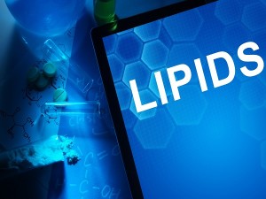 Tablet with the word lipids. Test tubes, tablets and chemical formulas.