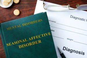 Seasonal affective disorder concept. Diagnostic form and book on a table.